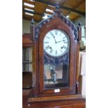 An American walnut and inlaid lancet cased mantle clock, 28' high