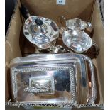 A pair of plated entrée dishes with covers and a three piece plated tea service