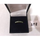 A 9ct nine stone green tourmaline ring. 1.3g gross. Size R½