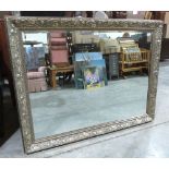 A wall mirror with silvered Art-Nouveau style moulded frame and bevelled plate. 43' x 55'