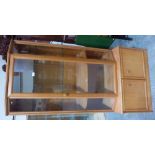 A glazed display cabinet on cupboard base