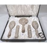 An Elizabeth II cased 6 piece silver backed dressing table set. Birmingham 1976. Appears unused