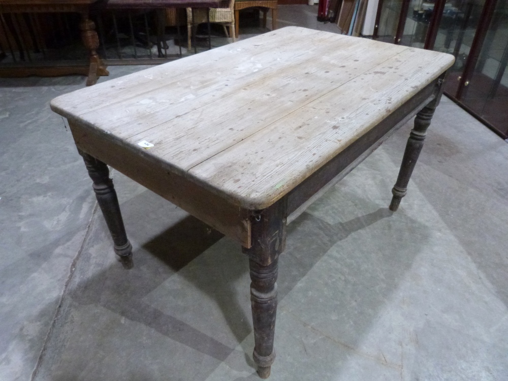 A Victorian pine kitchen table on turned legs. 52' long. (Formerly with a frieze drawer, now lacking
