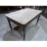 A Victorian pine kitchen table on turned legs. 52' long. (Formerly with a frieze drawer, now lacking