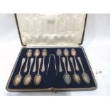 A George V cased set of twelve silver teaspoons and sugar bow. London 1926-27. 5ozs 5dwts