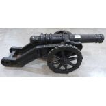 An iron cannon garden ornament. 29' long