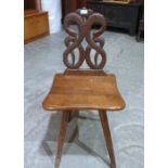 A mahogany hall chair with interlaced serpent carved back on fluted square legs. (One leg with