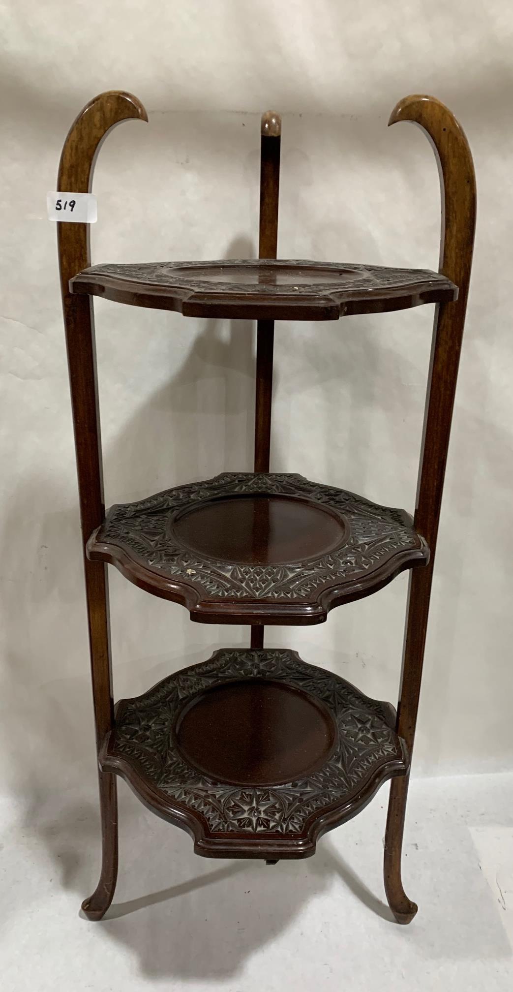 A mahogany carved three tier cake stand