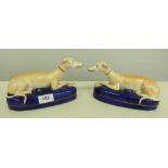 A pair of Staffordshire recumbent greyhound pen stands. 8¼' long
