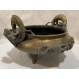 A BRONZE TRIPOD CENSER. QING DYNASTY The compressed body supported on three legs, the rim set with