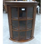 A mahogany bowfronted hanging corner cupboard. 26' high