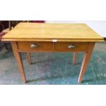 A light oak side table with two frieze drawers on square tapered legs. 41' wide
