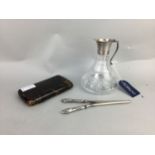 A SILVER COLLARED JUG ALONG WITH A PAIR OF GLOVE STRETCHERS AND A CIGARETTE CASE