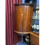 A GEORGE III MAHOGANY BOW FRONT HANGING CORNER CUPBOARD