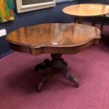 A WALNUT OVAL CENTRE TABLE AND A MODERN COFFEE TABLE