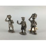 A SILVER FIGURE OF A MARKET SELLER AND TWO OTHER SIMILAR FIGURES