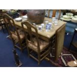 A PINE EXTENDING DINING TABLE AND FOUR CHAIRS