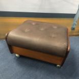 A BROWN LEATHER AND STAINED WOOD FOOTSTOOL