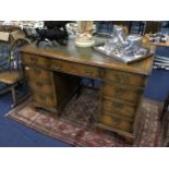 A LEATHER TOPPED PEDESTAL DESK