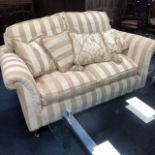 A CREAM AND GOLD FABRIC SETTEE AND ANOTHER SETTEE