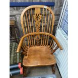 A STAINED WOOD WINDSOR STYLE ARMCHAIR