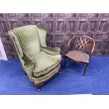 A 20TH CENTURY UPHOLSTERED WING BACKED ARMCHAIR AND A CANE PANELLED ARMCHAIR