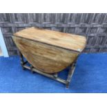 AN OAK DROP LEAF DINING TABLE