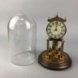 A MANTEL CLOCK UNDER A GLASS DOME