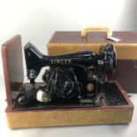 A 1957 VINTAGE SINGER PORTABLE SEWING MACHINE