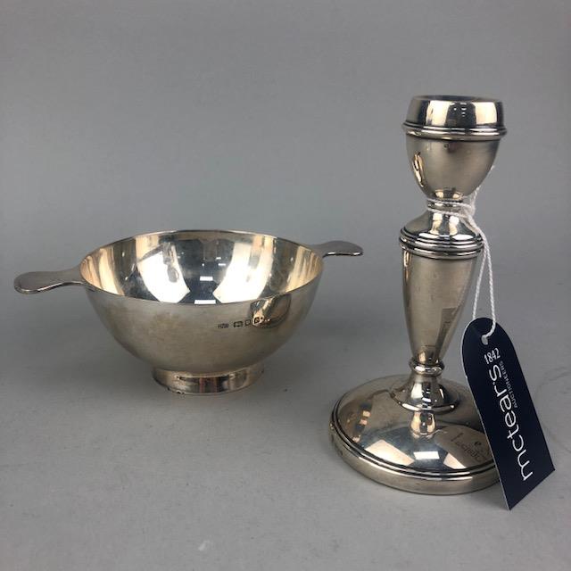 A SILVER QUAICH AND A SILVER CANDLESTICK