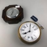 A MAHOGANY WALL BAROMETER AND A BRASS CLOCK