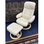 A MODERN CREAM LEATHER ARMCHAIR WITH STOOL