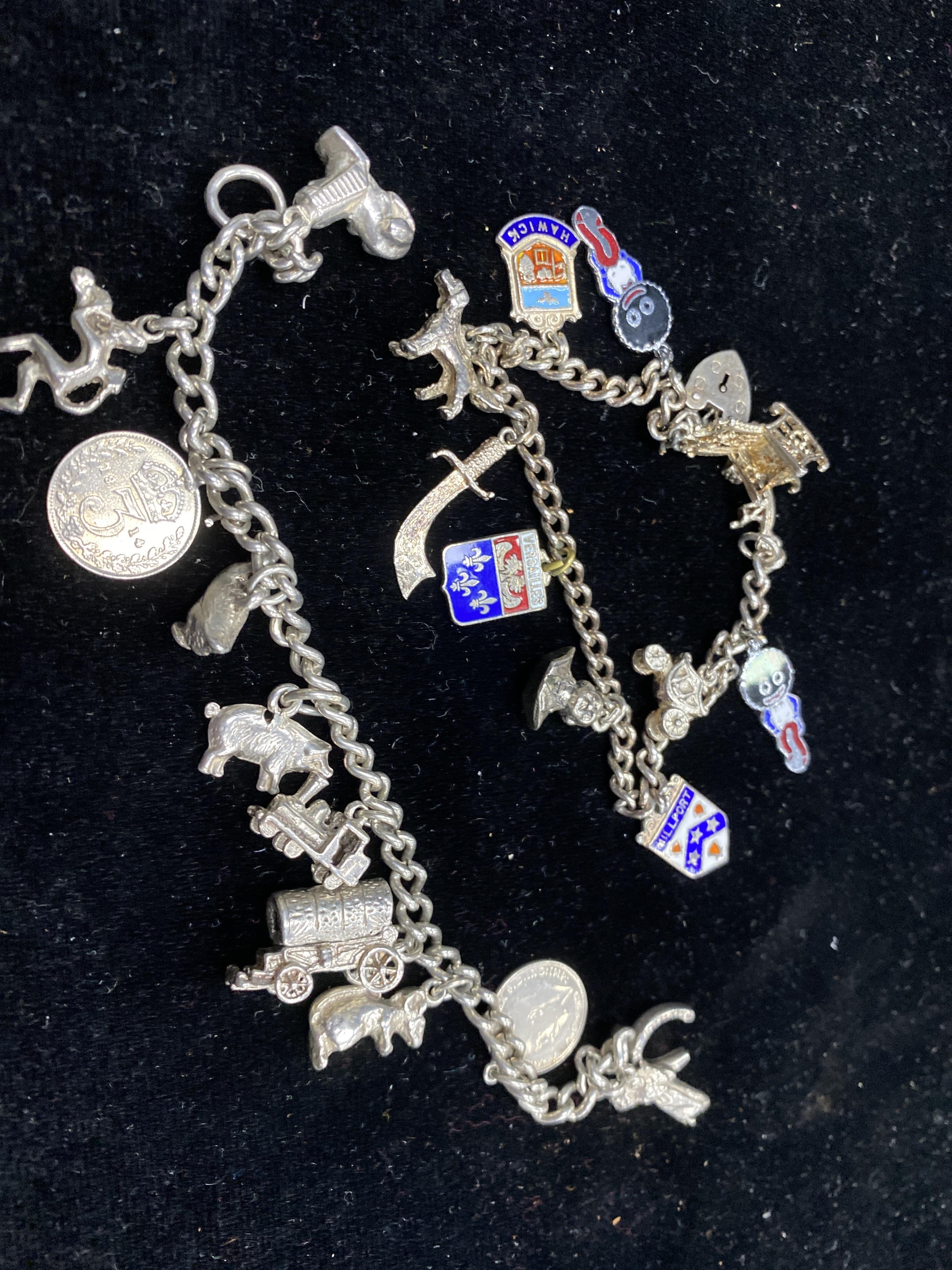 A LOT OF TWO SILVER CHARM BRACELETS