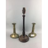 A PAIR OF BRASS CANDLESTICKS AND CARVED WOOD TABLE LAMP