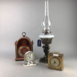 A REPRODUCTION CAST BRASS OIL LAMP AND THREE CLOCKS