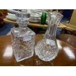 A STUART CRYSTAL VASE, DECANTERS AND VASES