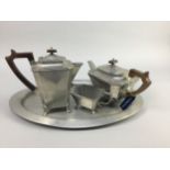 AN EARLY 20TH CENTURY HAMMERED DON PEWTER FOUR PIECE TEA SERVICE