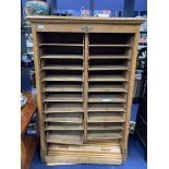 AN EARLY 20TH CENTURY OAK SHUTTER FRONT MUSIC CABINET