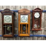 A LOT OF TWO STAINED WOOD WALL CLOCKS AND ANOTHER CLOCK