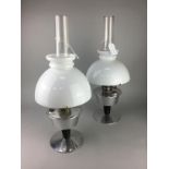 A PAIR OF PARAFFIN STYLE TABLE LAMPS AND A BRASS ELECTRIC LAMP