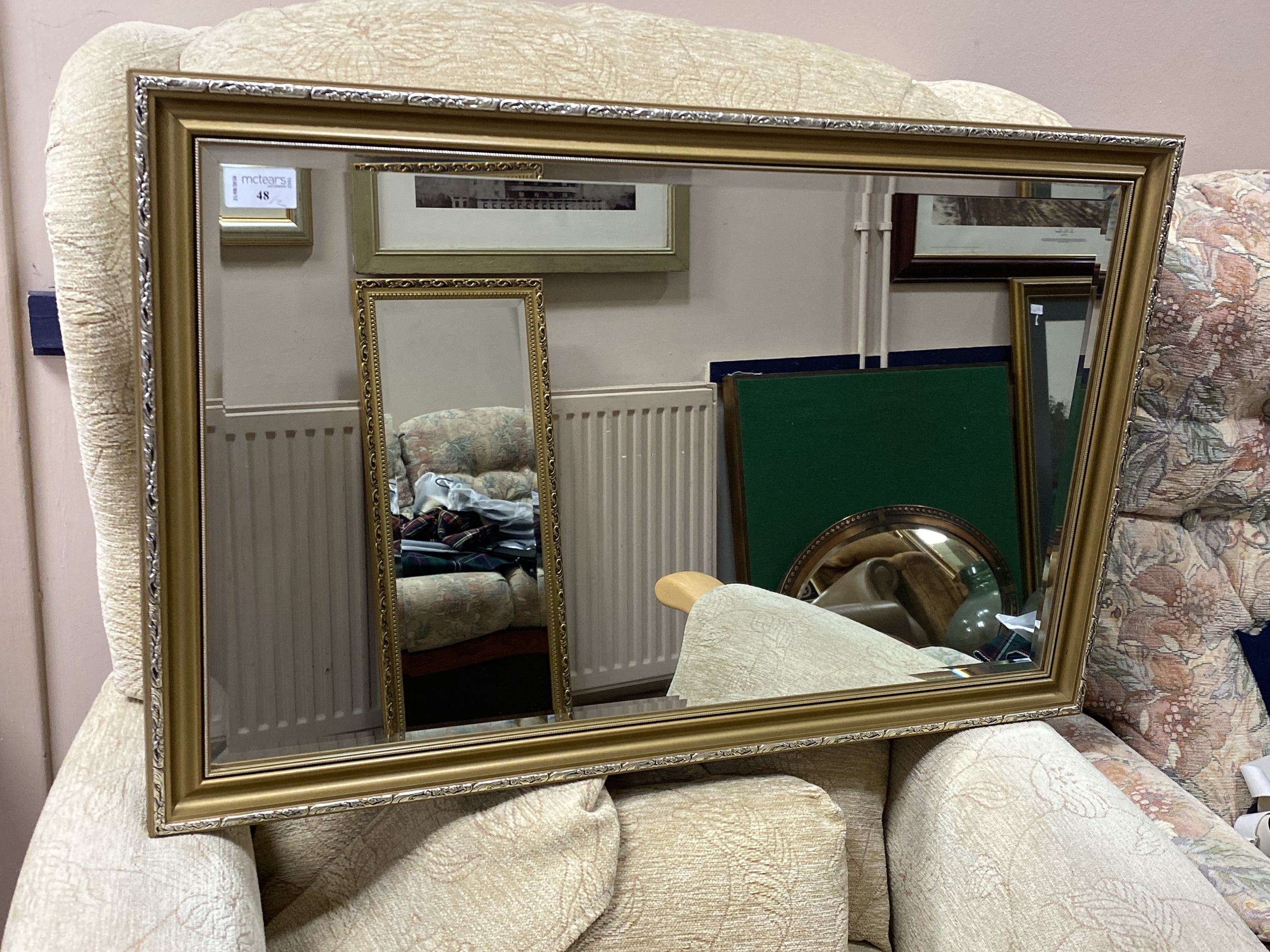 A GILT FRAMED WALL MIRROR