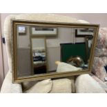 A GILT FRAMED WALL MIRROR