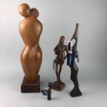 A WOOD SCULPTURE OF TWO FIGURES AND OTHERS