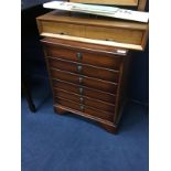 A CHEST OF DRAWERS, DRESSING MIRROR AND A SHELF