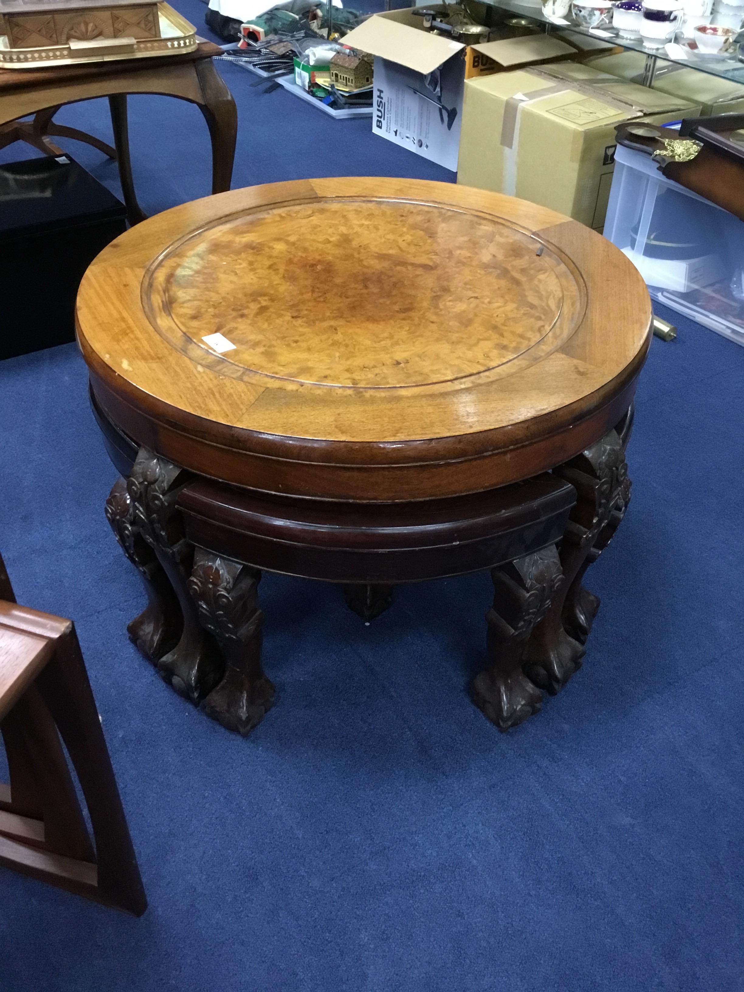 A BURR WALNUT COFFEE TABLE FITTED WITH FOUR TRIANGULAR OCCASIONAL TABLES