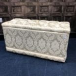 AN UPHOLSTERED OTTOMAN