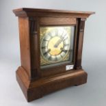 AN EARLY 20TH CENTURY OAK CASED MANTEL CLOCK