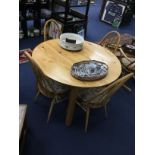 A PINE CIRCULAR DINING TABLE AND FOUR CHAIRS