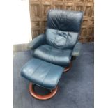 A BLUE LEATHER RECLINING CHAIR AND MATCHING FOOTSTOOL
