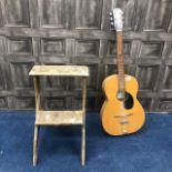 AN ACOUSTIC GUITAR ALONG WITH STEPS AND A COAL BOX